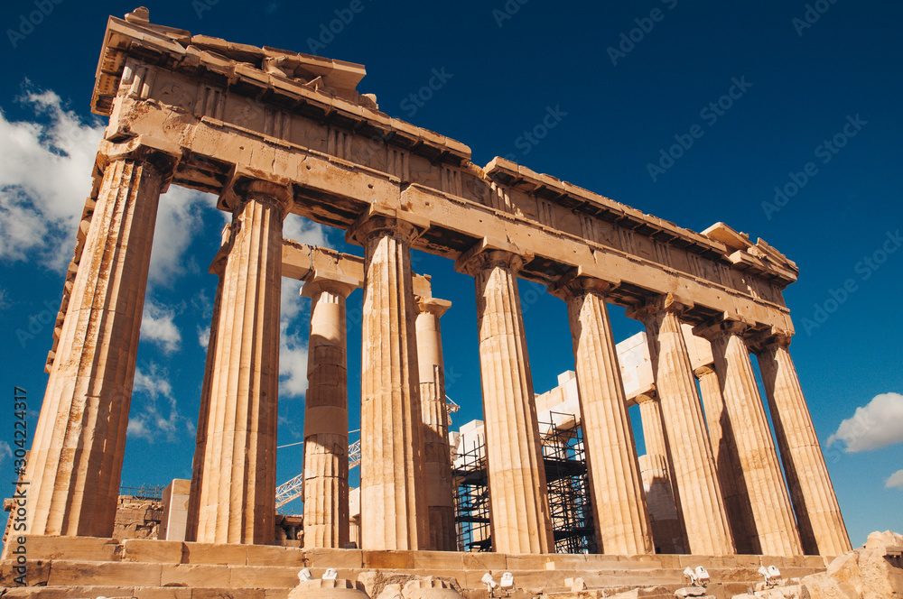 View of doric columns in the eastern side of the Parthenon in the Acropolis, Athens, Greece. Concept: classical culture, famous monuments, ancient history, cultural travel, visiting unesco heritage