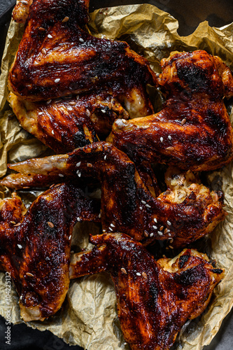 Grilled chicken wings in honey sauce. Farm organic meat. Top view. Black background