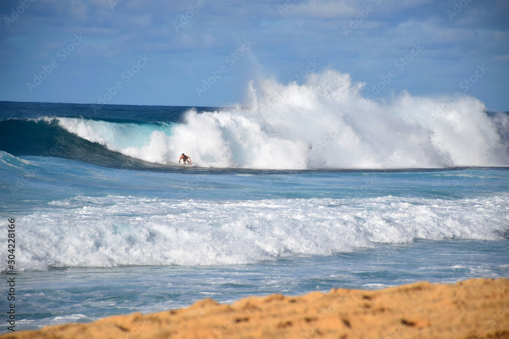 Fototapeta premium 7/10: Hawaiian Surfer Taking on a Massive Rainbow Wave at the Banzai Pipeline, Oahu, Hawaii
