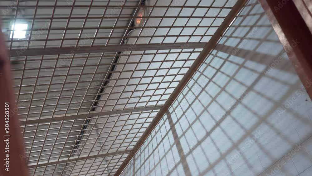 metal bars in the prison corridor against the background of a light bulb. metal bars in the prison corridor against the background of a light bulb.