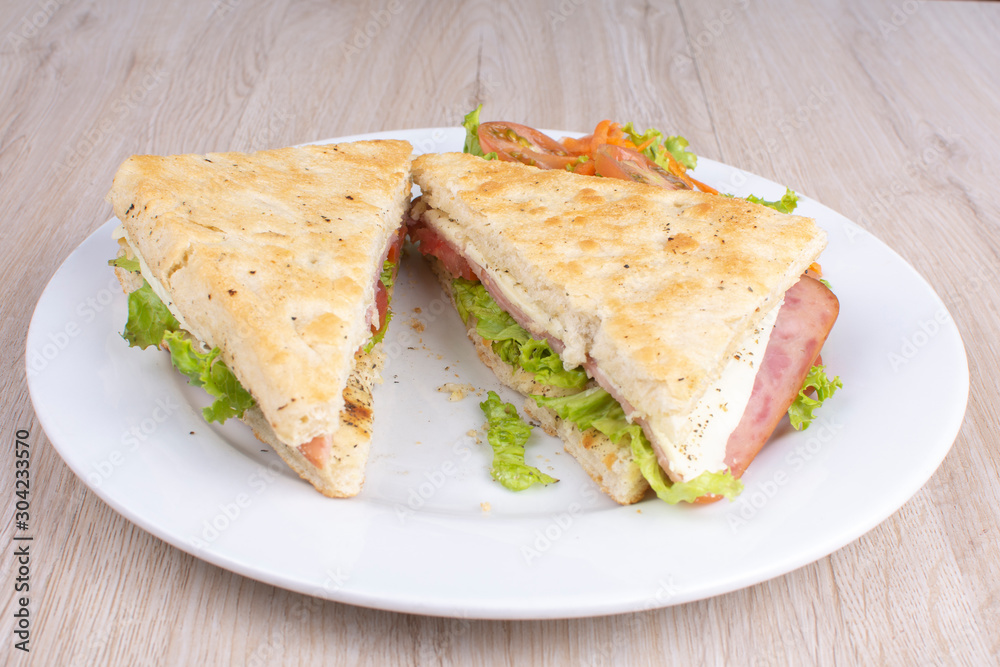 Craft sandwich with oregano, ham, cheese and salad