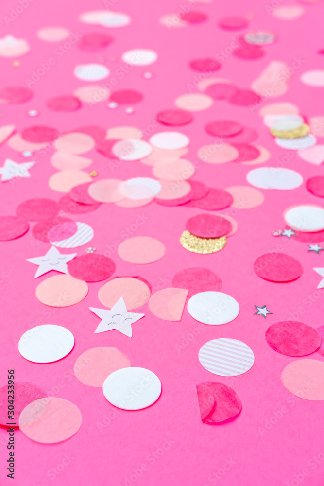 Obraz premium Multicolor pink, gold and white confetti on the bold pink background, holiday celebration backdrop, Flat lay style