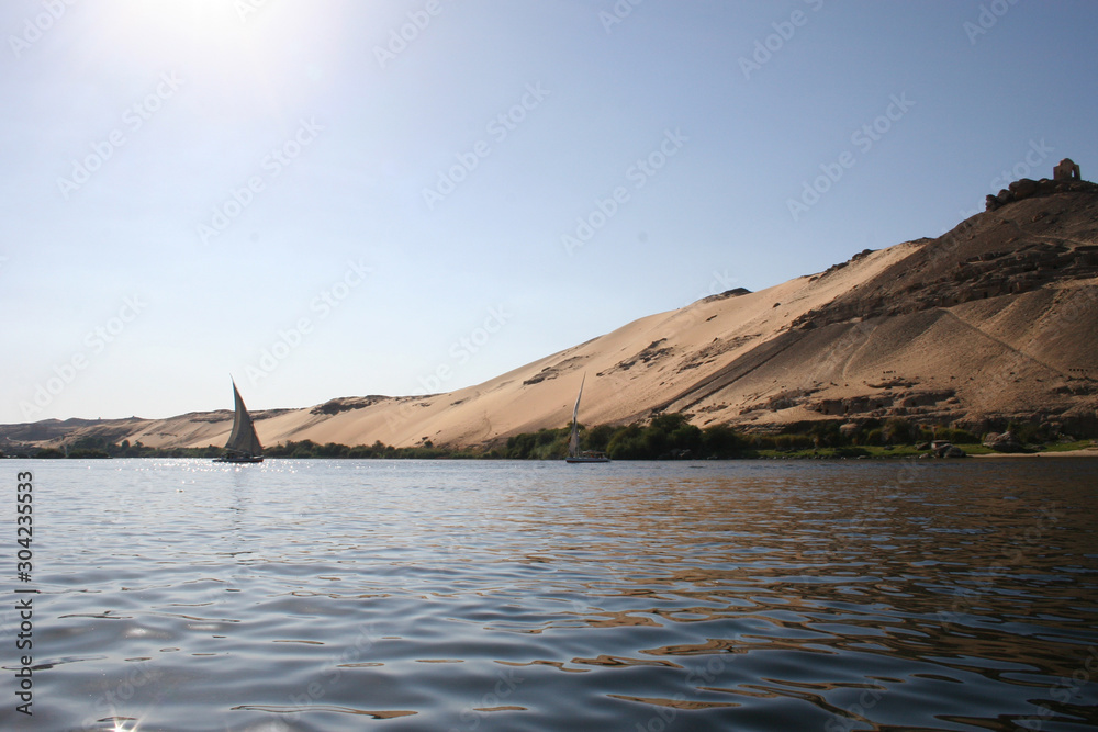 boat on the river Nile with sand dunes