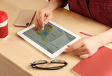 Woman using calendar app on tablet in office, closeup