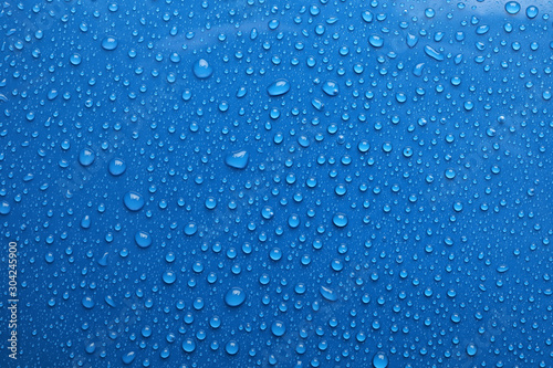 Water drops on blue background, top view Fotobehang