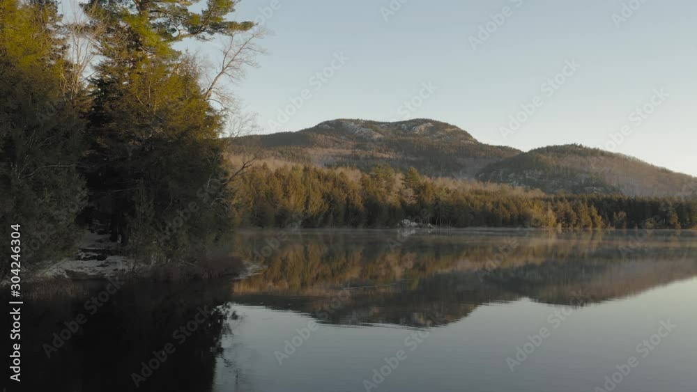 Dawn on peaceful lake shoreline forestry aerial Dawn on peaceful lake shoreline forestry aerial