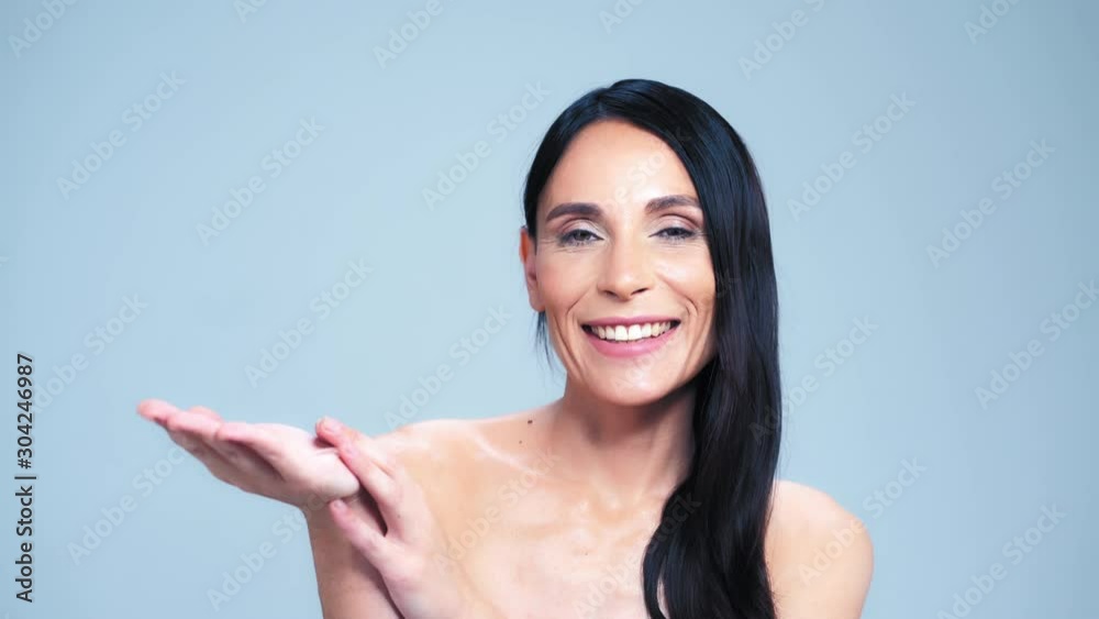 Charming Woman With Naked Shoulders Is Raising Her Hand Up With A Palm Uppermost. Charming Woman With Naked Shoulders Is Raising Her Hand Up With A Palm Uppermost.
