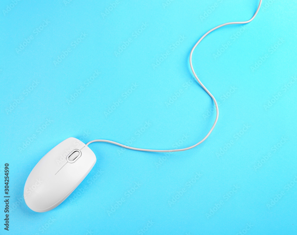 Modern wired mouse on light blue background, top view Modern wired mouse on light blue background, top view