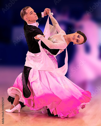 Beatiful ballroom dancers gliding across the floor