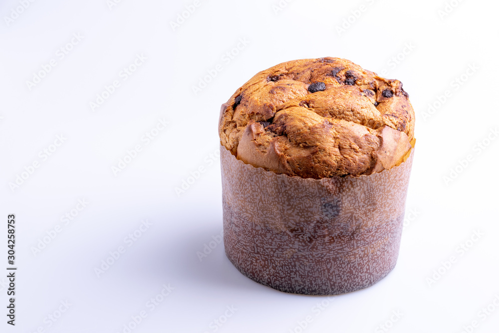 Christmas chocolate cake panettone on white background, soft light, angle view, also know as chocotone panetone, copy space Christmas chocolate cake panettone on white background, soft light, angle view, also know as chocotone panetone, copy space