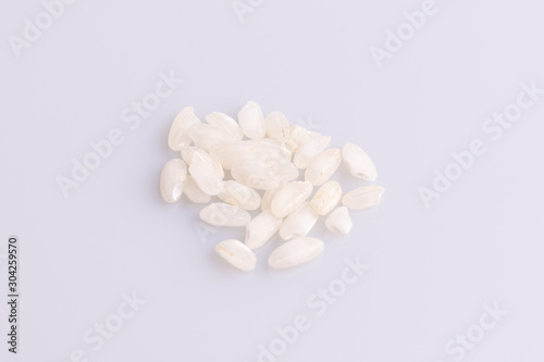Italian Risotto rice on white background. Copy Space. Soft light. Latin term "Oryza sativa". Carnaroli rice. Vialone Nano rice.