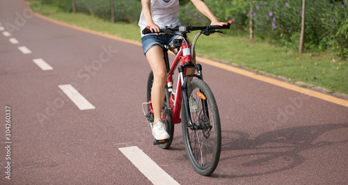 Woman riding bike in park