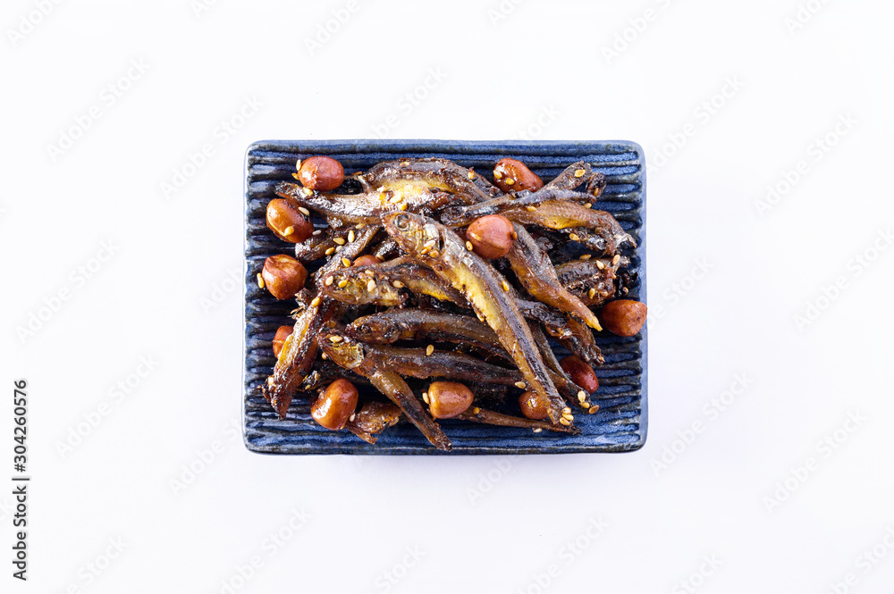 Tazukuri, candied sardines. Dried sardines lightly coated with honey, roasted sesame and peanuts. Tazukuri, candied sardines. Dried sardines lightly coated with honey, roasted sesame and peanuts.