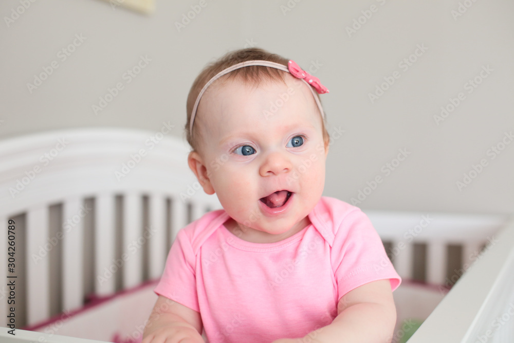 Close up Portrait of Cute 8 Month Old baby Girl with Big blue Eyes, Happy Baby Girl