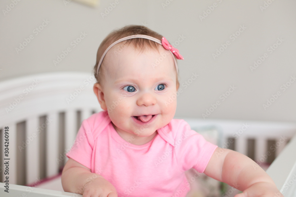 Close up Portrait of Cute 8 Month Old baby Girl with Big blue Eyes, Happy Baby Girl