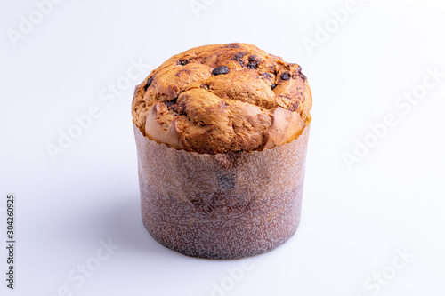 Christmas chocolate cake panettone on white background, soft light, angle view, also know as chocotone panetone, copy space photo