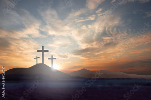 Fotografiet cross the crucifixion on the mountain jesus christ with a sunset background