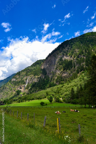 mountain valley landscape and waterfall with big clouds in the valleys of austria