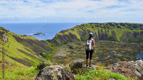Young woman on the edge of the Ra-nu Kao volcano on Easter Island. Chile