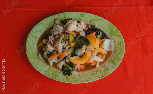 Braised vegetables in sauce in colorful Asian restaurant