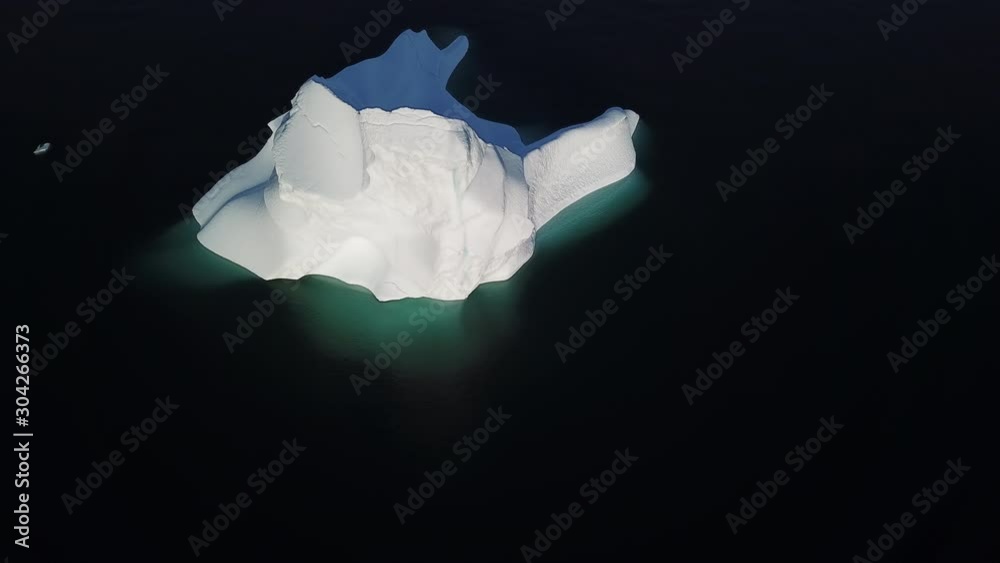 Iceberg and ice from glacier in arctic nature landscape on Greenland. Aerial video drone footage of icebergs in Ilulissat icefjord. Affected by climate change and global warming. Iceberg and ice from glacier in arctic nature landscape on Greenland. Aerial video drone footage of icebergs in Ilulissat icefjord. Affected by climate change and global warming.
