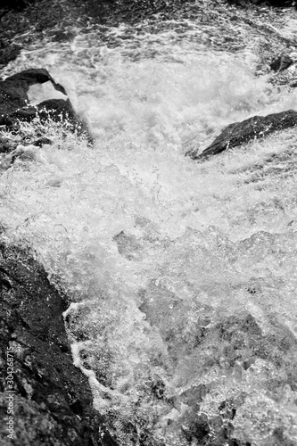 Close up view of the rushing waters of a waterfall.