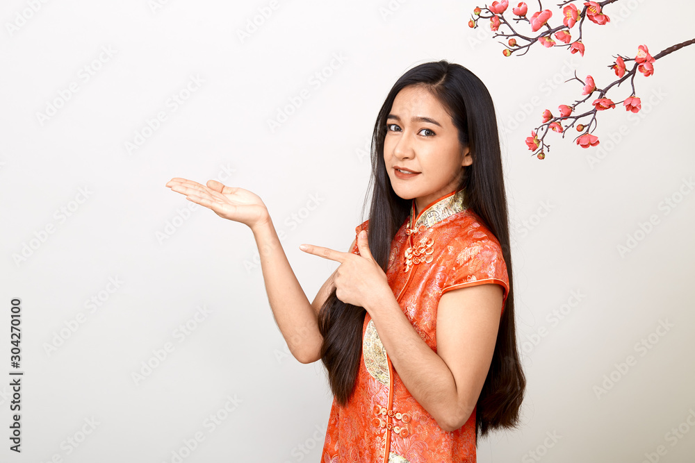 Woman in traditional chinese red dress with plum flowers Woman in traditional chinese red dress with plum flowers