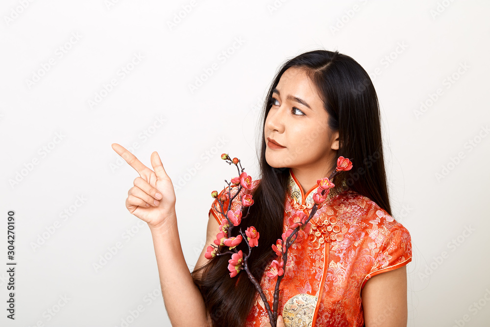 Woman in traditional chinese red dress with plum flowers Woman in traditional chinese red dress with plum flowers
