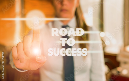 Word writing text Road To Success. Business photo showcasing studying really hard Improve yourself to reach dreams wishes Blurred woman in the background pointing with finger in empty space