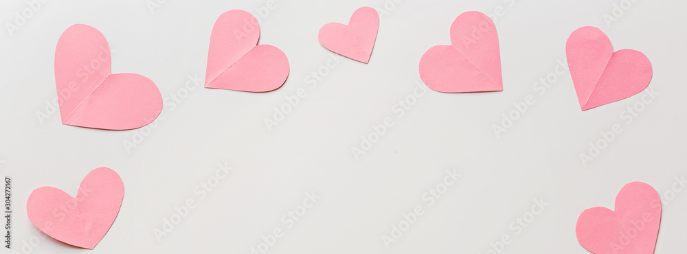 Valentine's day background with pink hearths on white. Flat lay, top view, mockup, template, copy space. Minimal abstract composition for 14 February celebration