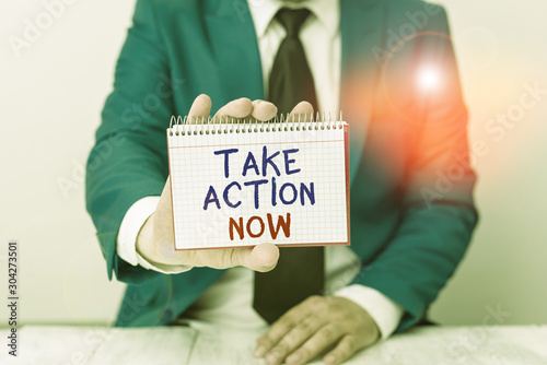 Conceptual hand writing showing Take Action Now. Concept meaning asking someone to start doing Good perforanalysisce Encourage Man holds empty paper with copy space in front of him Space photo