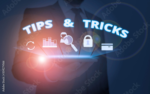 Writing note showing Tips And Tricks. Business concept for Steps Lifehacks Handy advice Recommendations Skills photo