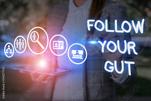 Conceptual hand writing showing Follow Your Gut. Concept meaning Listen to intuition feelings emotions conscious perception