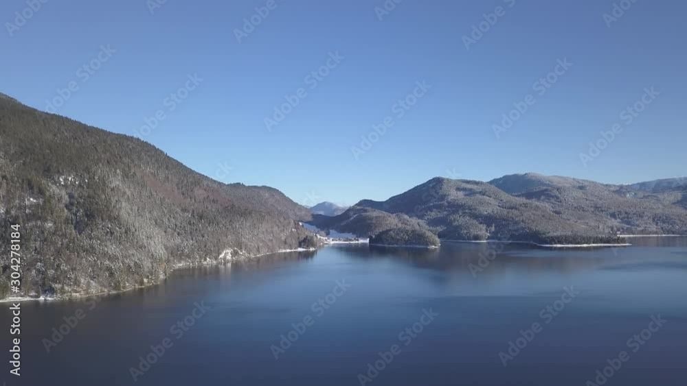 Aerial view, Descending flight over Walchensee Lake towards snowy shore, Upper Bavaria, Germany (NO COLOR GRADE) Aerial view, Descending flight over Walchensee Lake towards snowy shore, Upper Bavaria, Germany (NO COLOR GRADE)