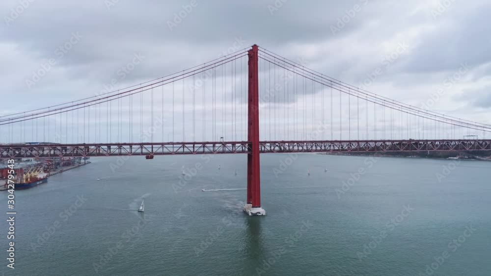 Aerial view over famous 25th of April Bridge at River Tejo in Lisbon - aerial drone footage Aerial view over famous 25th of April Bridge at River Tejo in Lisbon - aerial drone footage