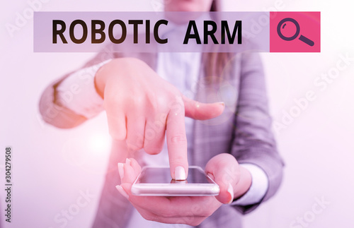 Writing note showing Robotic Arm. Business concept for programmable mechanical arm with similar function of a huanalysis arm Business woman points with finger on touch screen