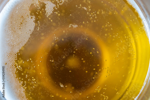 Close up of thet op of a glass of beer photo