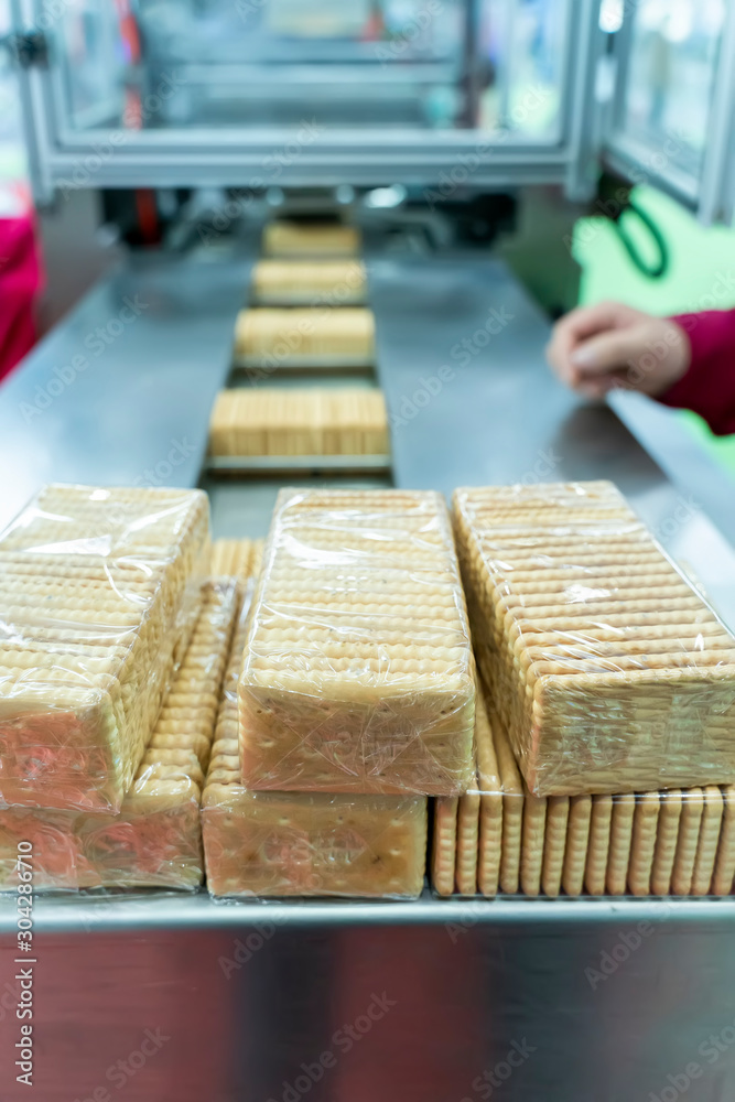 automate robot conveyor in Production of biscuits in a manufacture factory for the food industry automate robot conveyor in Production of biscuits in a manufacture factory for the food industry