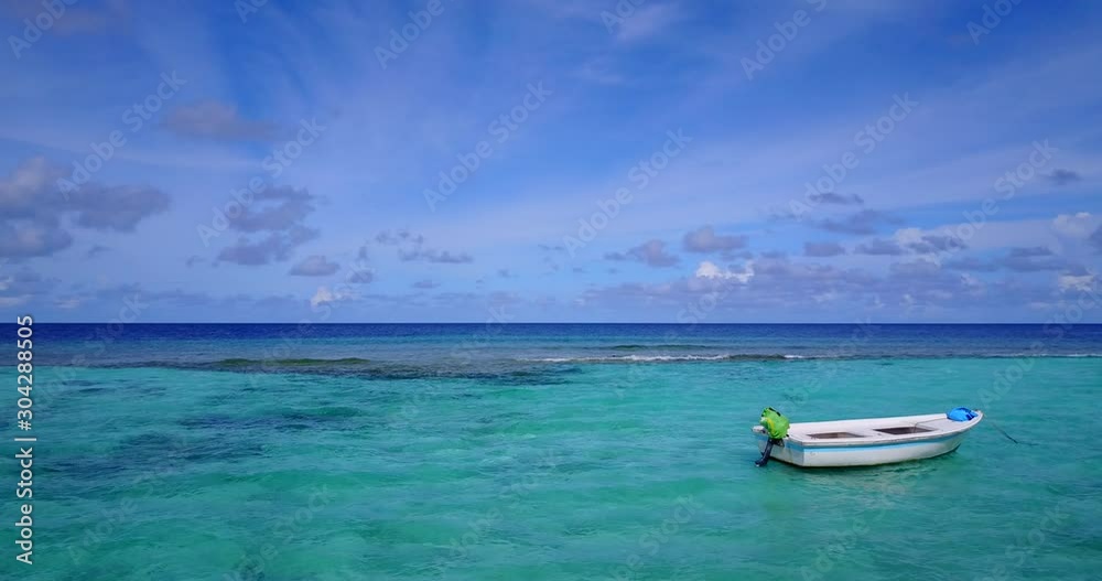 Small motor boats anchored on calm clear turquoise lagoon divided from deep blue ocean by coral reef barrier in Australia Small motor boats anchored on calm clear turquoise lagoon divided from deep blue ocean by coral reef barrier in Australia