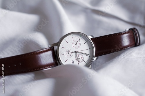 dark brown leather men's watches with white display on white background