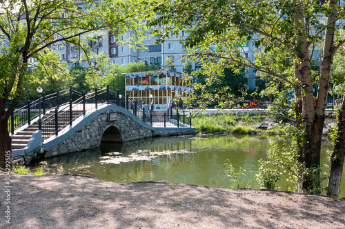 Russia, Blagoveshchensk, July 2019: stone bridge over the pond in the friendship Park in the city of Blagoveshchensk in the summer