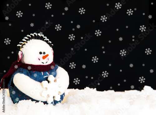 Happy Snowman in snow on black background. Holiday theme