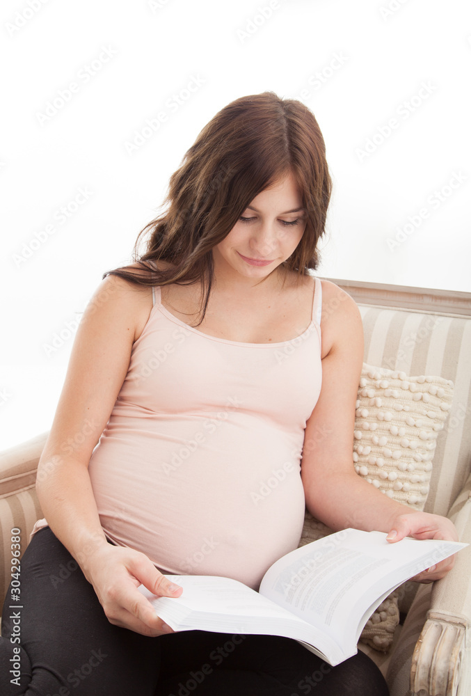 Pregnant expectant mother reading book