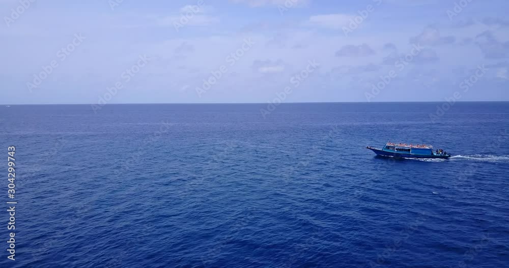 An Island In Tahiti - A Boat Swiftly Sailing Across The Deep Blue Sea With People On Board - Wide Shot An Island In Tahiti - A Boat Swiftly Sailing Across The Deep Blue Sea With People On Board - Wide Shot