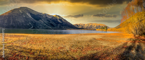 Autumn colours at a peaceful tranquil lake in rural South Island New Zealand