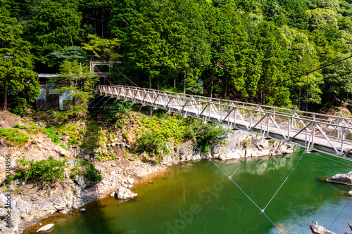 Hozukyo river and a suspension bridge "Ukai bridge" over Trolly Hozukyo station. Arashiyama, Nishikyo-ku, Kyoto-shi, Kyoto