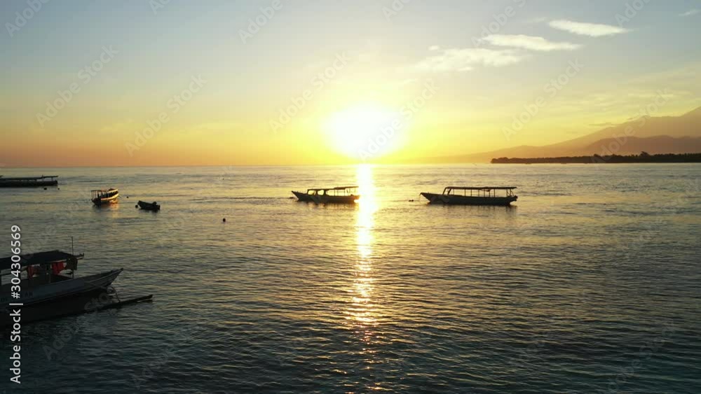 Tale Boats With Golden Sunset On The Background. Tropical islands, summer vacation concept Tale Boats With Golden Sunset On The Background. Tropical islands, summer vacation concept