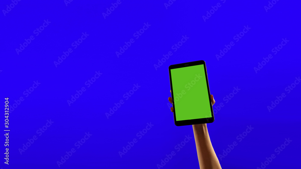 An outstretched hand shows the tablet. Blue screen, green screen An outstretched hand shows the tablet. Blue screen, green screen