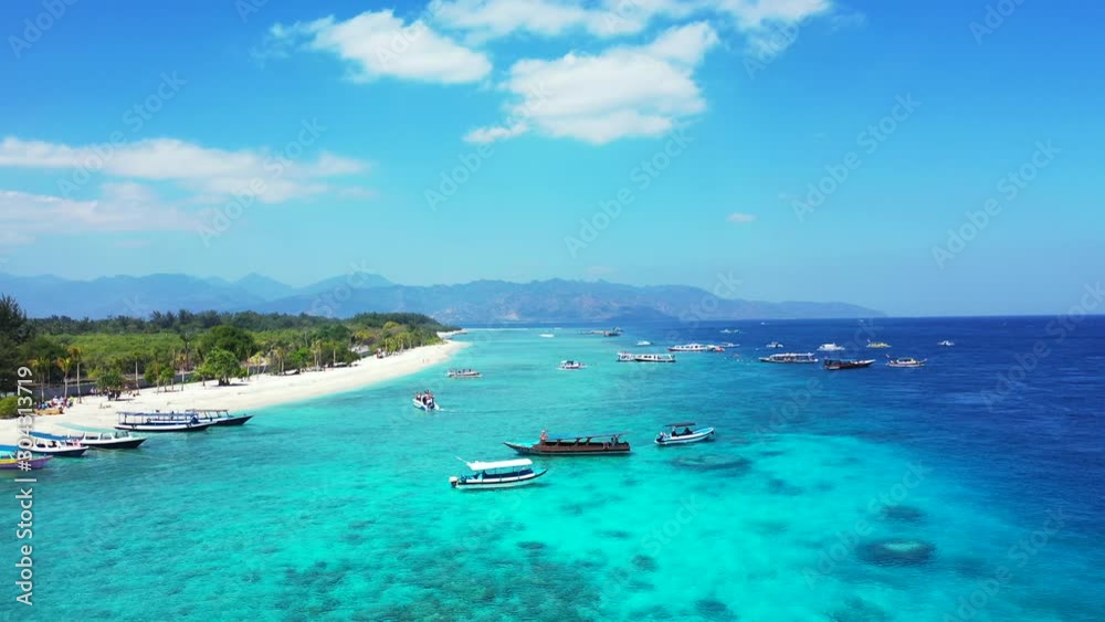moored boats in the turquoise calm sea near the tropical small island with white beaches and palms moored boats in the turquoise calm sea near the tropical small island with white beaches and palms