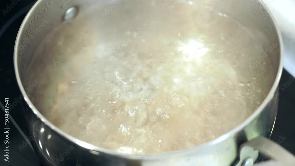boiling water in a pot, cooking. water boils boiling water in a pot, cooking. water boils